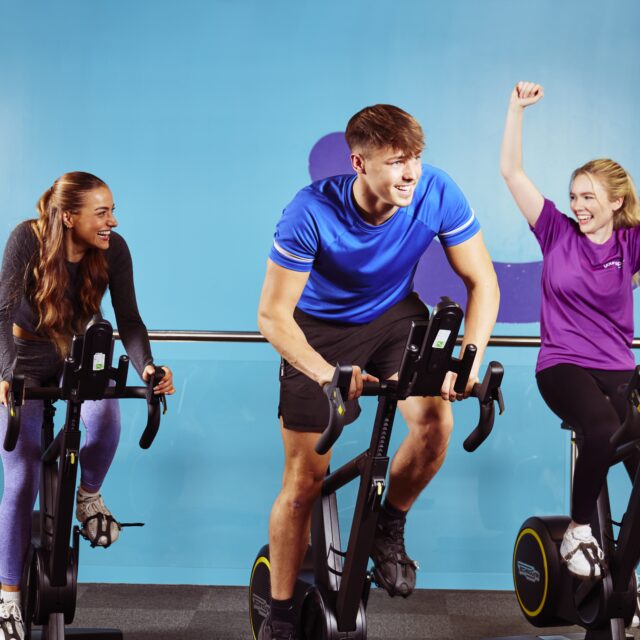 people on indoor bikes in a gym